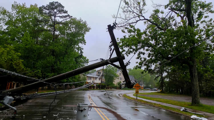 Fallen power line blocking wet residential street